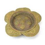 An Eastern brass and copper finished table centre of flower-head form,