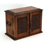 A Victorian and later oak smoker's cabinet, the doors enclosing a fitted interior, w.