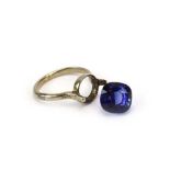 A white metal dress ring set blue coloured stone,