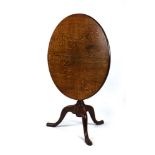 An 18th century oak tripod table with a birdcage mechanism,