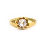 A yellow metal signet ring set old cut moissanite in an eight claw setting,