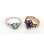 A white metal ring set pale blue glass and small diamonds,