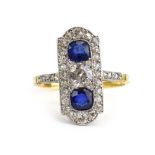 An 18ct yellow gold and platinum highlighted ring set brilliant cut diamond and two sapphires