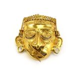 A 14ct yellow gold brooch in the form of a South American tribal head, l. 3.4 cm, 17.
