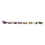 Eight silver dress rings set stones including Russian diopside, coral, peach moonstone and others,