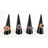 Four 9ct yellow gold and yellow metal dress rings set coral, coloured stones etc.