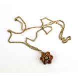 A 9ct yellow gold flat curblink necklace suspending a late 19th/early 20th century flowerhead