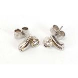 A pair of 18ct white gold ear studs, each set a small brilliant cut diamond in a rubover setting,