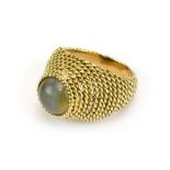 Boucheron, a yellow gold bombe ring set cabochon moonstone within a ropetwist setting,