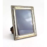 A modern silver easel back photograph frame of rectangular form with beaded border, Carrs,