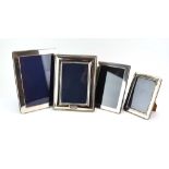 Four silver easel back photograph frames of rectangular form, various dates and makers, max h.