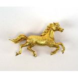 An 18ct yellow gold brooch in the form of a prancing horse, its eye set small diamonds,