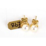 A pair of 9ct yellow gold ear sets, each set a cultured pearl, d. 6 mm, 1.