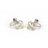 A pair of 14ct white gold screw-type earrings, each set brilliant synthetic stone, l. 1.5 cm, 6.