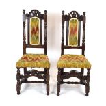 A pair of late 17th century side chairs with later upholstery on turned legs with shaped aprons