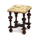 A late Georgian mahogany stool with a cross-stretcher and turned bulbous supports