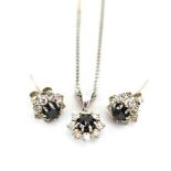 An 18ct white gold flat curblink necklace suspending a cluster pendant set black diamond in a