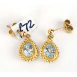 A pair of 9ct yellow gold ear pendants, each set teardrop topaz within a beaded border, l. 1.