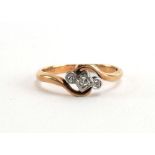 A 9ct yellow gold and platinum highlighted ring set three small diamonds in illusion settings,