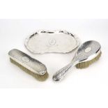 An Edwardian hammered silver dressing table tray of pinched oval form,