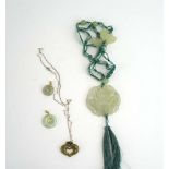 A pale green jade-type necklace with butterfly decoration,