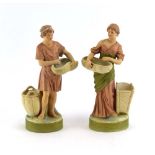A pair of Royal Dux shot enamel figures modelled as a harvest gatherer and her male companion, h.