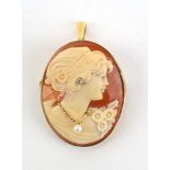 A 9ct yellow gold cameo pendant/brooch of oval form depicting a classical female head and shoulders