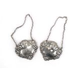 A pair of silver decanter labels repousse decorated in the Rococo manner, maker T&S,