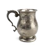 An Edwardian silver and parcel gilt cream jug of typical form with leaf capped c-scroll handle,