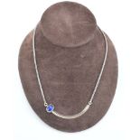 A silver articulated link necklace suspending a parcel gilt pendant set lapis lazuli,