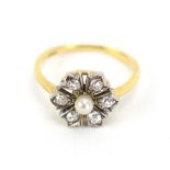 An early 20th century 18ct yellow gold ring set small pearl and six small old cut diamonds in a