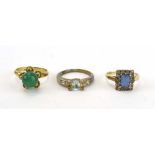 A yellow metal ring set jade type stone, a 9ct yellow gold dress ring set clear and blue paste,