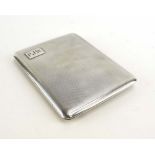A silver, parcel gilt and engine turned cigarette case of cushioned rectangular form, Mappin & Webb,