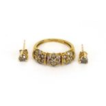 A 9ct yellow gold ring set champagne diamonds in flowerhead settings,