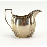 An Edwardian silver cream jug of helmet form, makers mark indistinct, London 1908, h. 9.