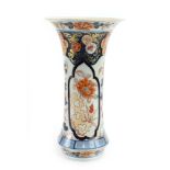 A 19th century Chinese vase of flared cylindrical form decorated with flowering shrubs in the Imari