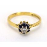 An 18ct yellow gold cluster ring set small diamond in a surround of six sapphires, ring size M 1/2,