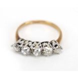 An early 20th century yellow metal ring set five graduated old cut diamonds,