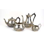 A late Victorian silver four piece tea service with gadrooned decoration,