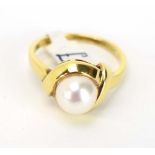 A 9ct yellow gold ring set cultured pearl in a crossover setting, pearl d. 7 mm, ring size N 1/2, 3.