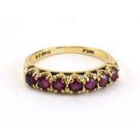 A 9ct yellow gold half eternity ring set seven pink coloured stones, ring size N 1/2, 2.
