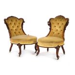 A pair of Victorian button-upholstered fireside chairs,
