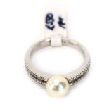 An 18ct white gold split band ring set cultured pearl and two rows of small diamonds, pearl d.