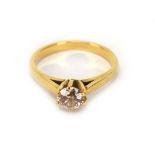 A yellow metal ring set brilliant cut diamond in a six claw setting, stone approximately 1 carat,