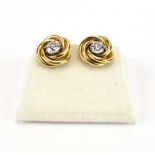 A pair of 18ct yellow gold screw-type ear studs of knot design, each set a brilliant cut diamond,