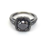 A 14ct gold halo ring set black diamond in a border of smaller black diamonds, ring size N, 4.