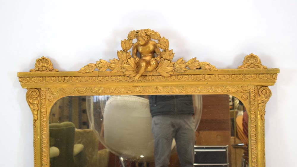 A George III and later giltwood overmantle mirror surmounted by a cherub and swag pediment, - Image 2 of 2