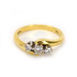 An 18ct yellow gold crossover ring set three graduated diamonds, ring size M 1/2, 3.