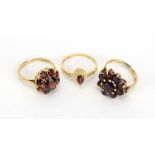 Three 9ct yellow gold dress rings set garnets, various sizes, overall 8.