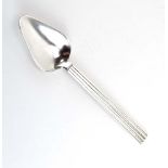 A silver grapefruit spoon with reeded handle, Georg Jensen, l. 15.